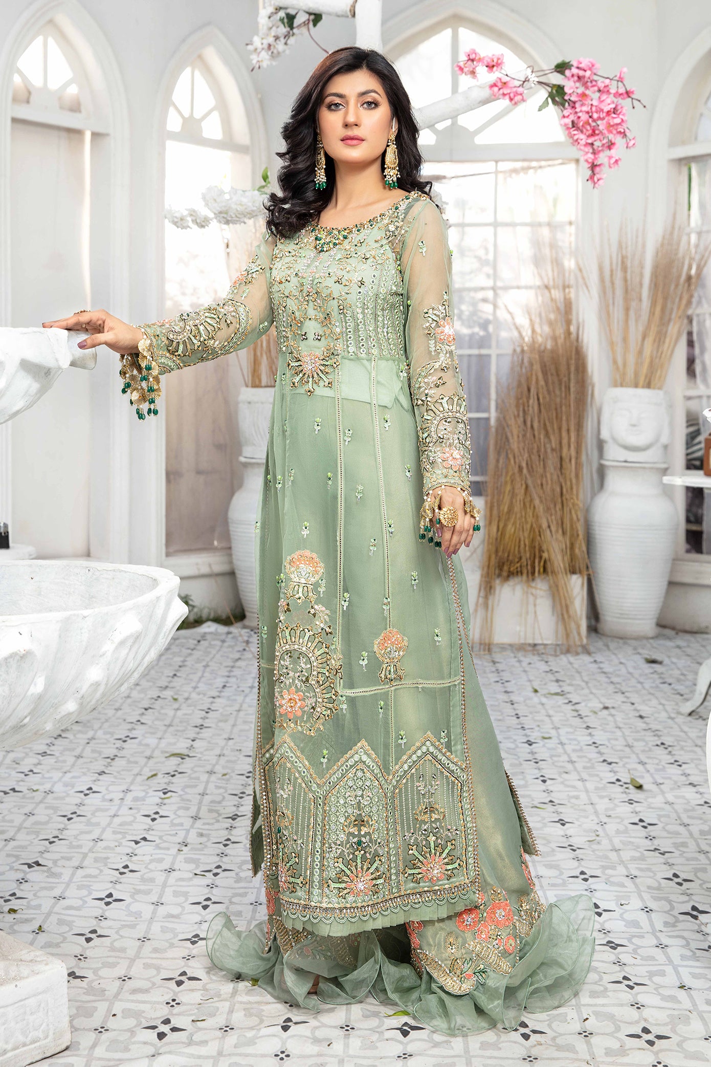 A mint green and peach Pakistani formal dress with intricate embroidery work in peach and green, paired with a peach-colored dupatta adorned with green embroidery. The dress is perfect for weddings and formal events, and the lightweight dupatta makes it comfortable to wear for extended periods.