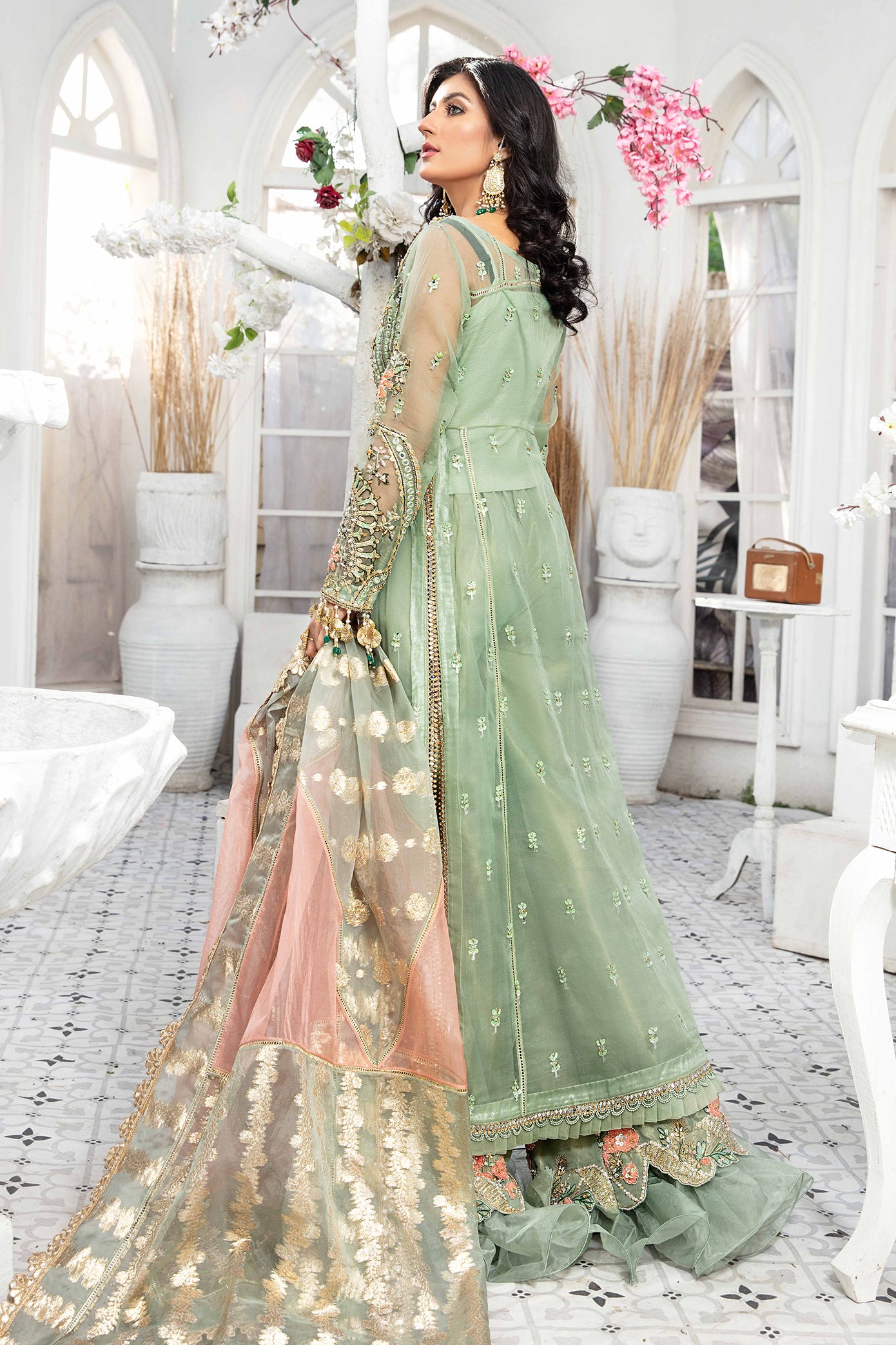 A mint green and peach Pakistani formal dress with intricate embroidery work in peach and green, paired with a peach-colored dupatta adorned with green embroidery. The dress is perfect for weddings and formal events, and the lightweight dupatta makes it comfortable to wear for extended periods.