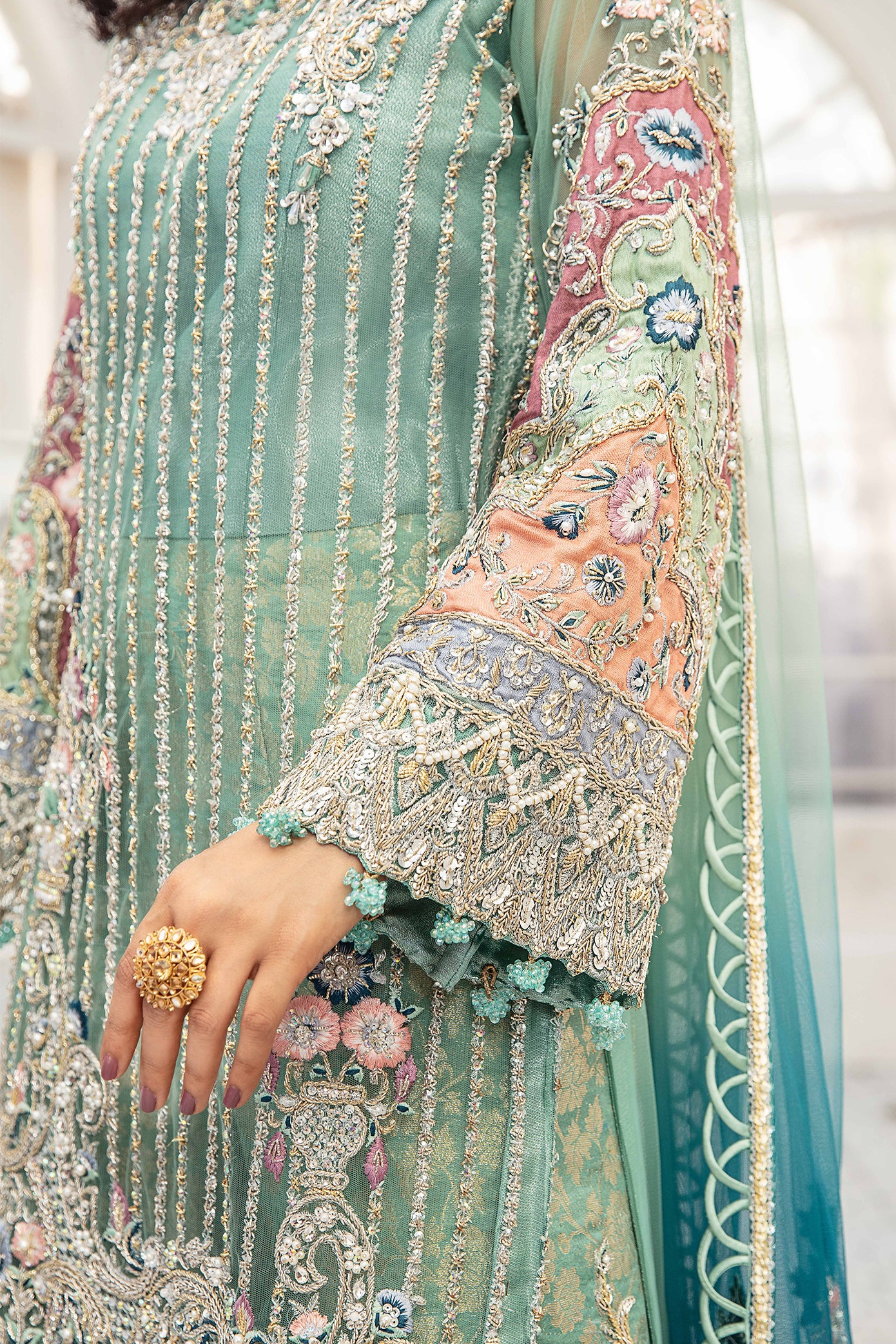 A beautiful turquoise blue double shaded Pakistani formal dress with intricate silver work on the bodice and sleeves. The dress features a lovely dupatta that complements the elegant design. Perfect for formal events and special occasions, this dress showcases traditional Pakistani style with its mesmerizing beauty and charm.