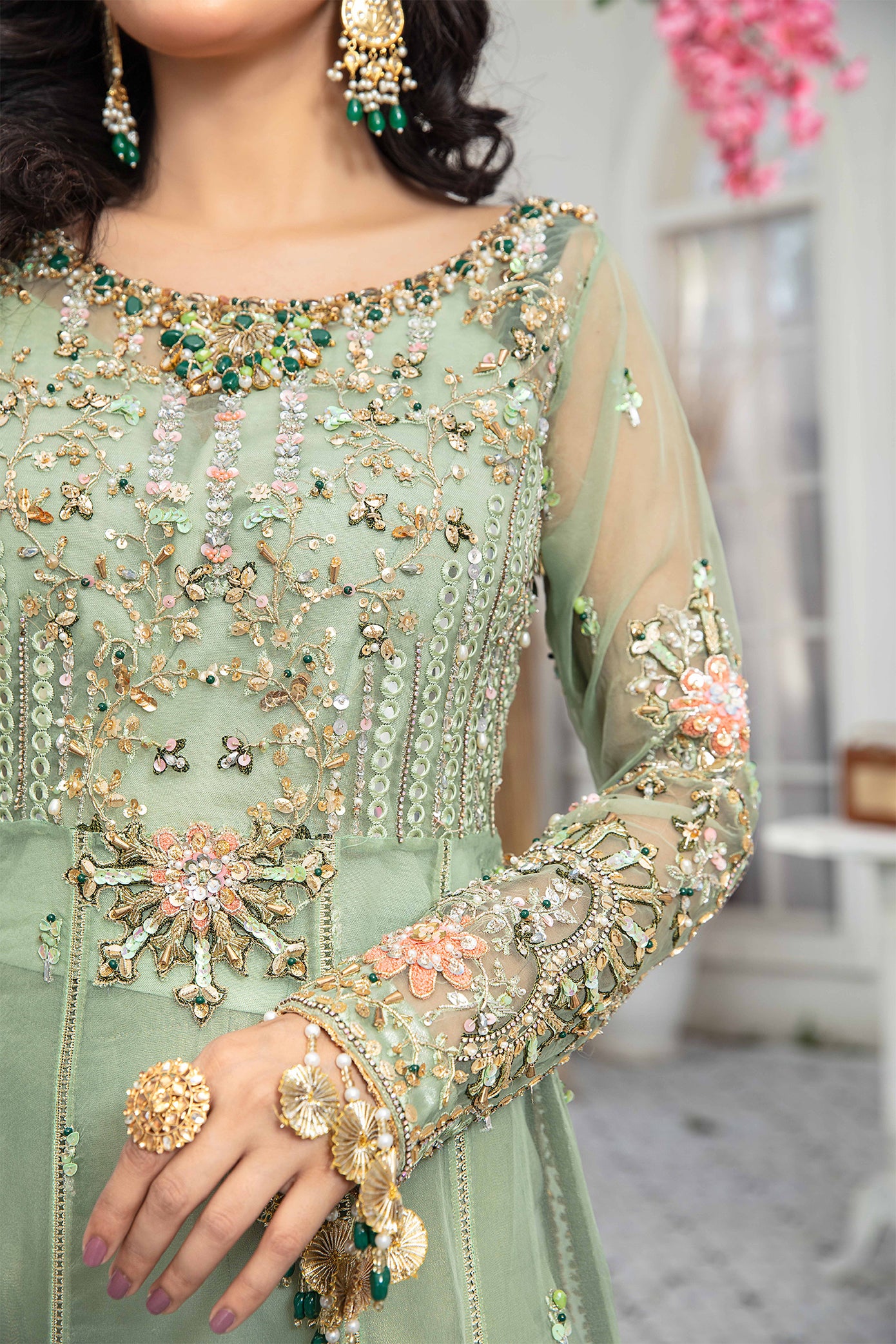 A mint green and peach Pakistani formal dress with intricate embroidery work in peach and green, paired with a peach-colored dupatta adorned with green embroidery. The dress is perfect for weddings and formal events, and the lightweight dupatta makes it comfortable to wear for extended periods.