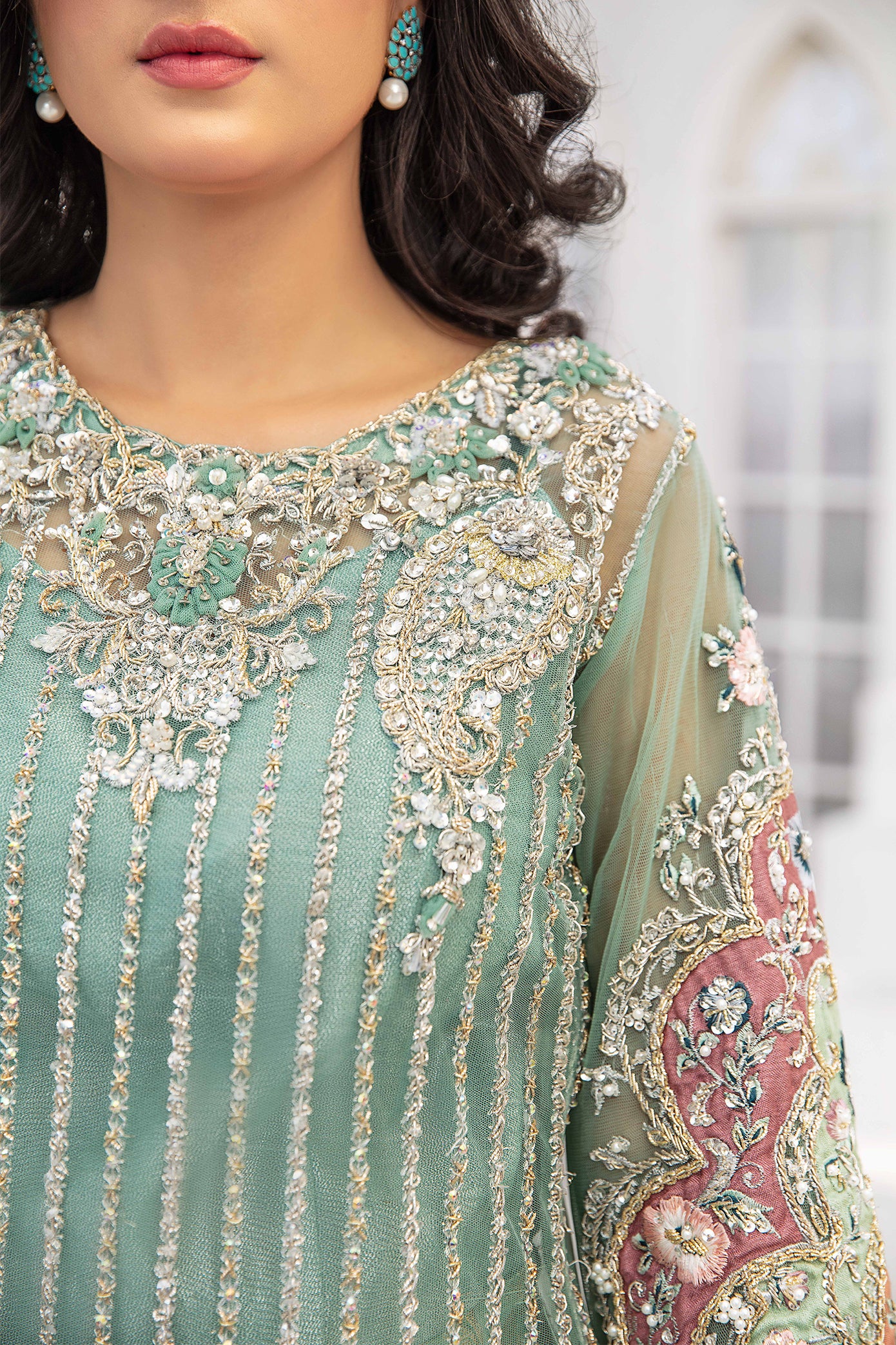 A beautiful turquoise blue double shaded Pakistani formal dress with intricate silver work on the bodice and sleeves. The dress features a lovely dupatta that complements the elegant design. Perfect for formal events and special occasions, this dress showcases traditional Pakistani style with its mesmerizing beauty and charm.
