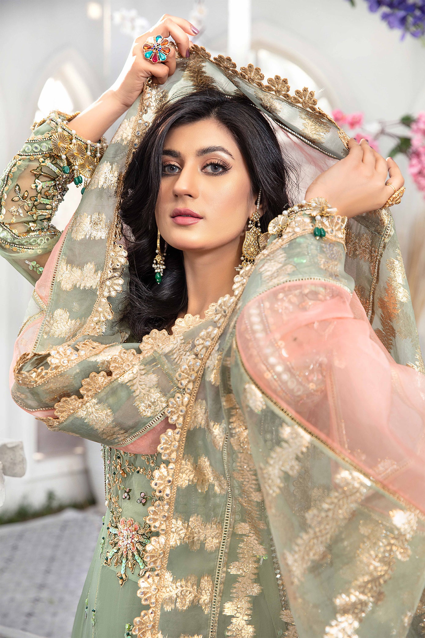 A mint green and peach Pakistani formal dress with intricate embroidery work in peach and green, paired with a peach-colored dupatta adorned with green embroidery. The dress is perfect for weddings and formal events, and the lightweight dupatta makes it comfortable to wear for extended periods.
