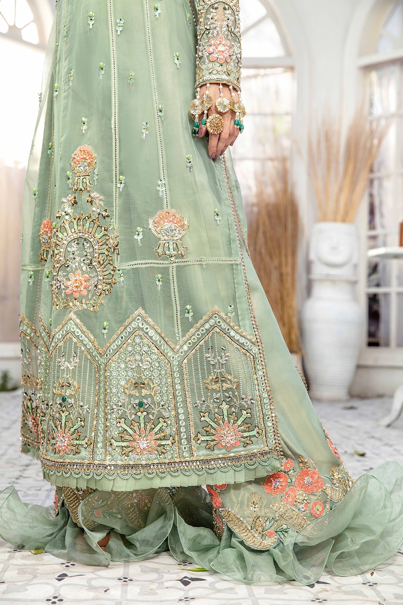 A mint green and peach Pakistani formal dress with intricate embroidery work in peach and green, paired with a peach-colored dupatta adorned with green embroidery. The dress is perfect for weddings and formal events, and the lightweight dupatta makes it comfortable to wear for extended periods.