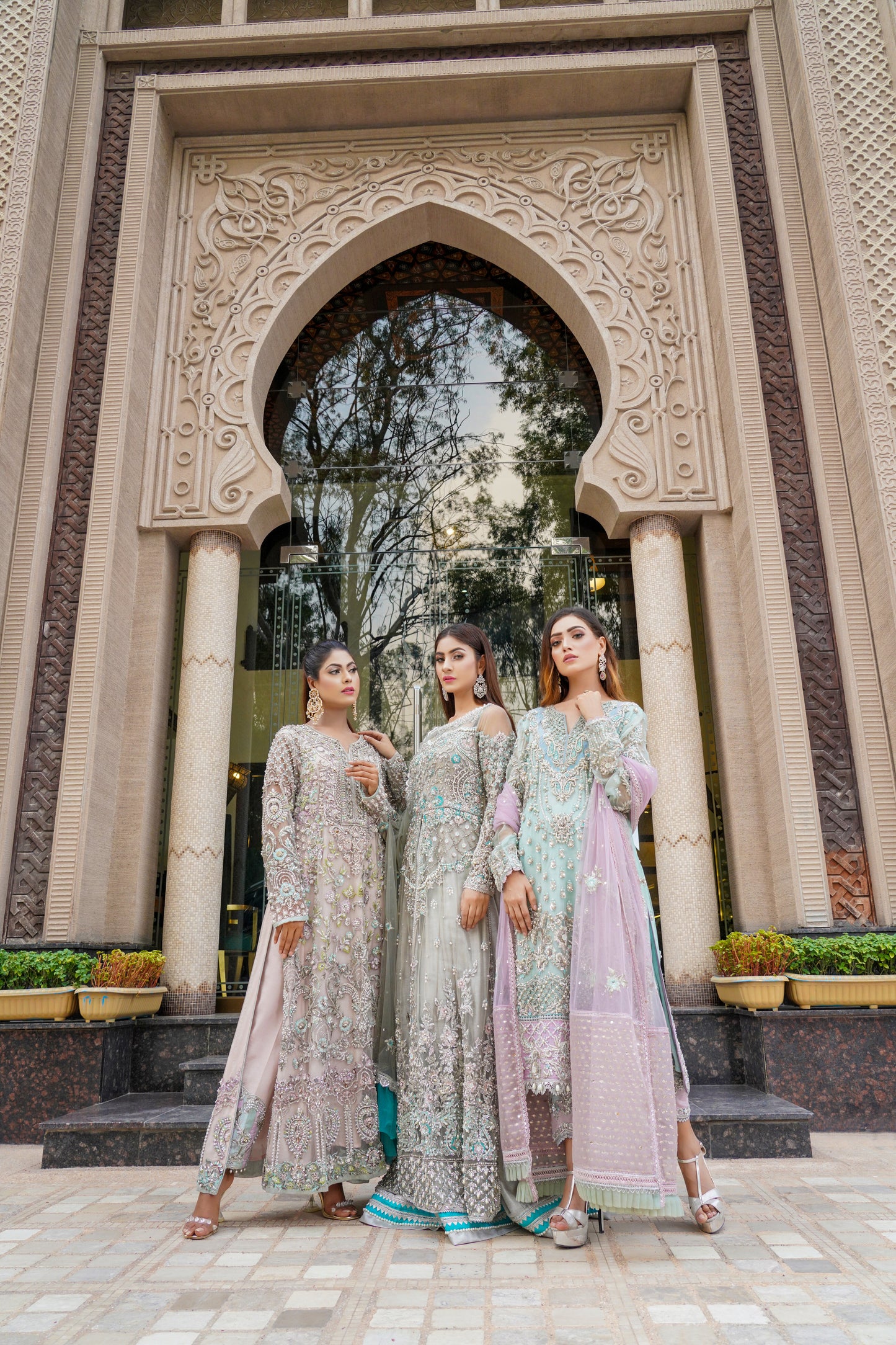 Ice blue Pakistani formal dress with intricate silver work and pink dupatta. Fitted bodice, flowing skirt, and delicate silver work throughout. Dazzling and elegant, perfect for formal events.