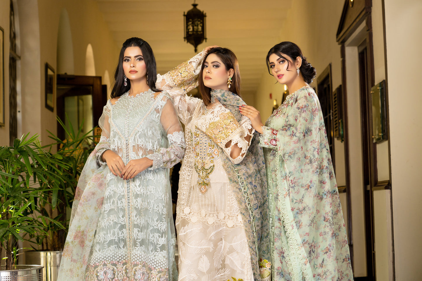 Off-white luxury Pret Pakistani dress with intricate gold work embellishments. Fitted bodice Voluminous skirt with swirling gold work pattern. Paired with a printed designed dupatta featuring floral and paisley prints in gold and off-white, finished with a matching gold trim