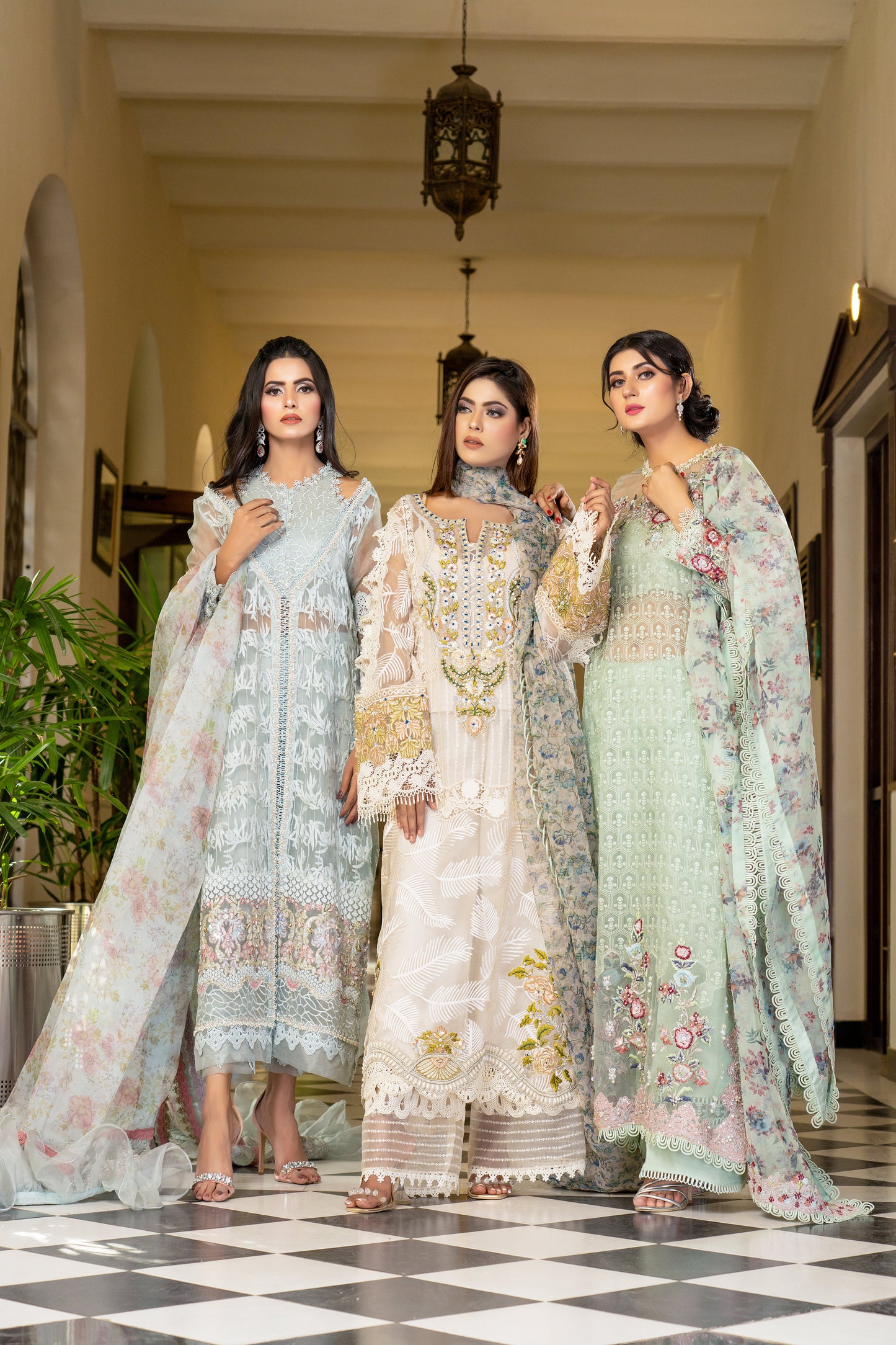 Off-white luxury Pret Pakistani dress with intricate gold work embellishments. Fitted bodice Voluminous skirt with swirling gold work pattern. Paired with a printed designed dupatta featuring floral and paisley prints in gold and off-white, finished with a matching gold trim