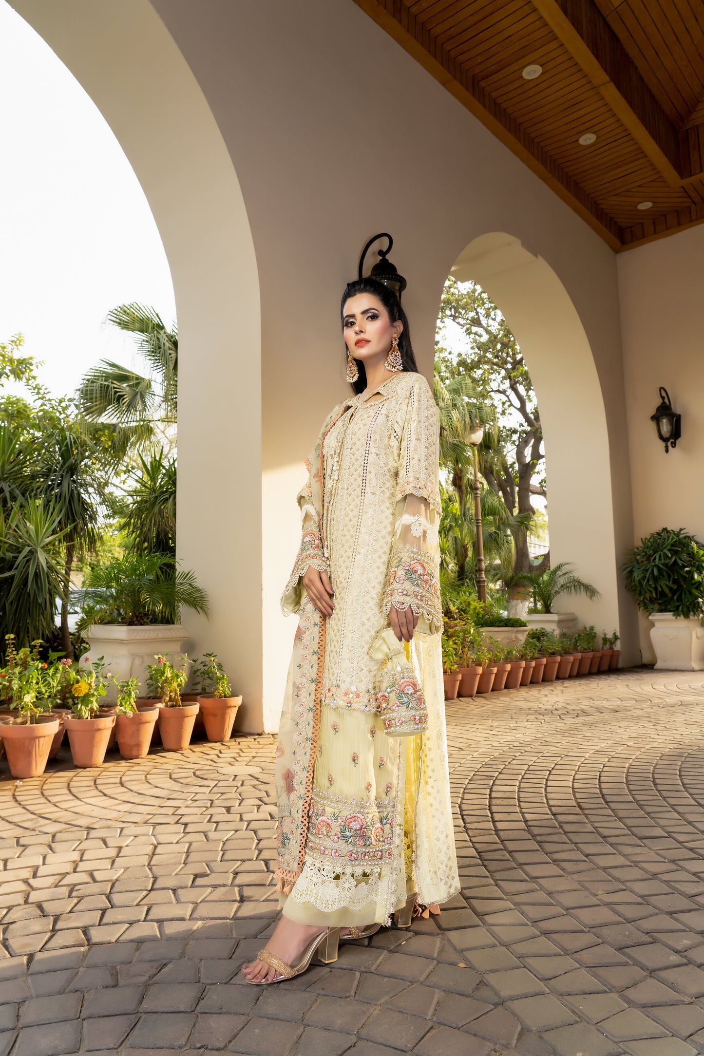 Yellow lime luxury Pret Pakistani dress with fitted bodice, voluminous skirt, and short sleeves. Paired with a printed designed dupatta featuring prints in shades of yellow and lime with a matching border. Perfect for formal events and designed with high-quality fabric and intricate details for both beauty and comfort.