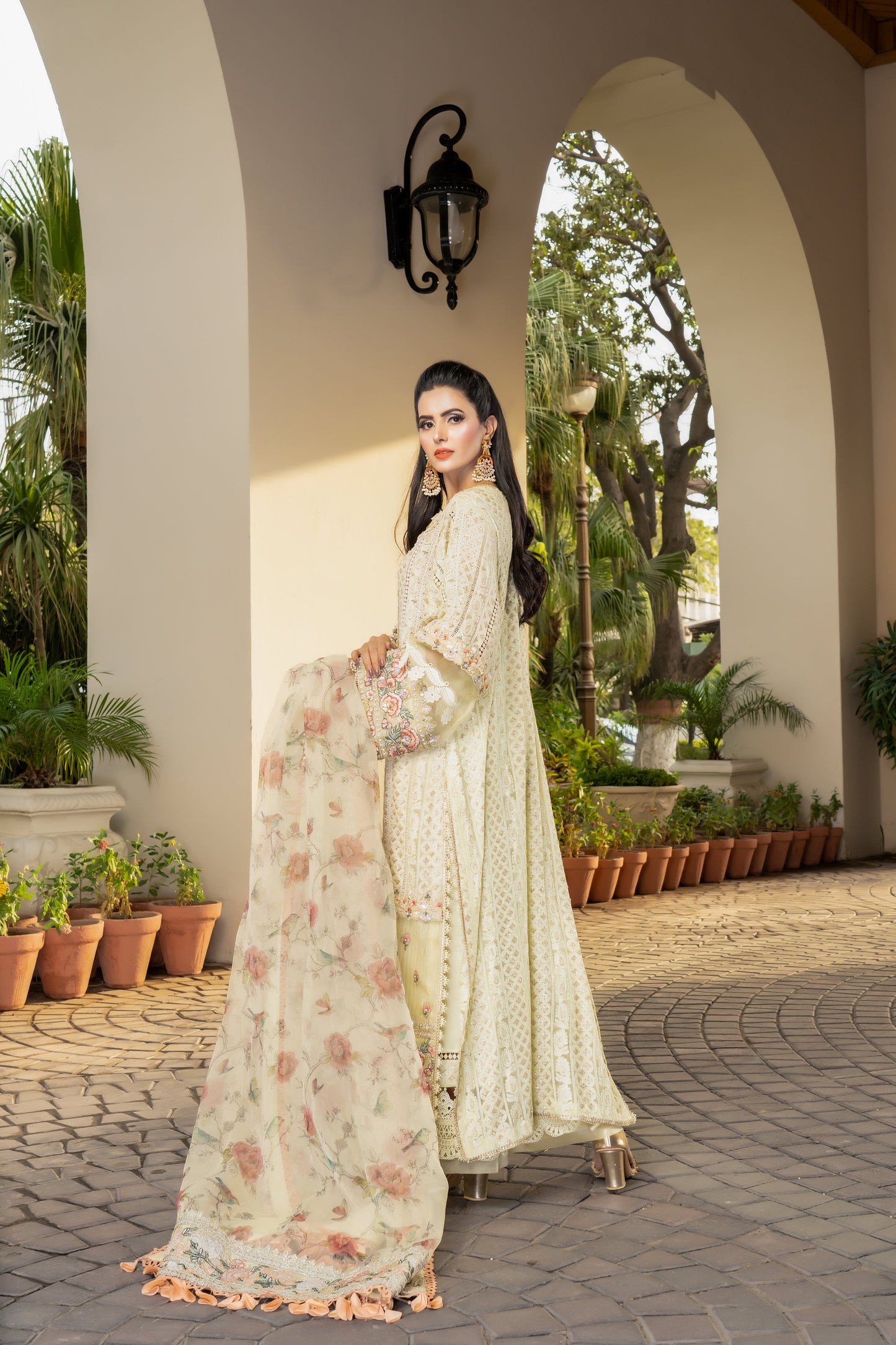 Yellow lime luxury Pret Pakistani dress with fitted bodice, voluminous skirt, and short sleeves. Paired with a printed designed dupatta featuring prints in shades of yellow and lime with a matching border. Perfect for formal events and designed with high-quality fabric and intricate details for both beauty and comfort.