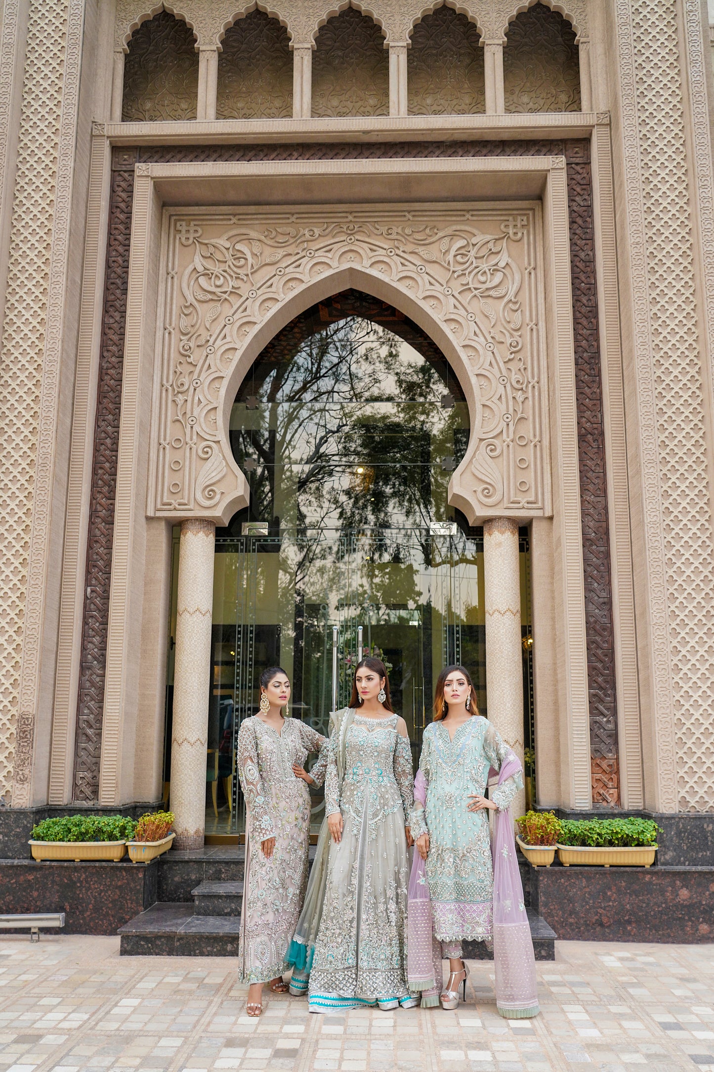 Ice blue Pakistani formal dress with intricate silver work and pink dupatta. Fitted bodice, flowing skirt, and delicate silver work throughout. Dazzling and elegant, perfect for formal events.