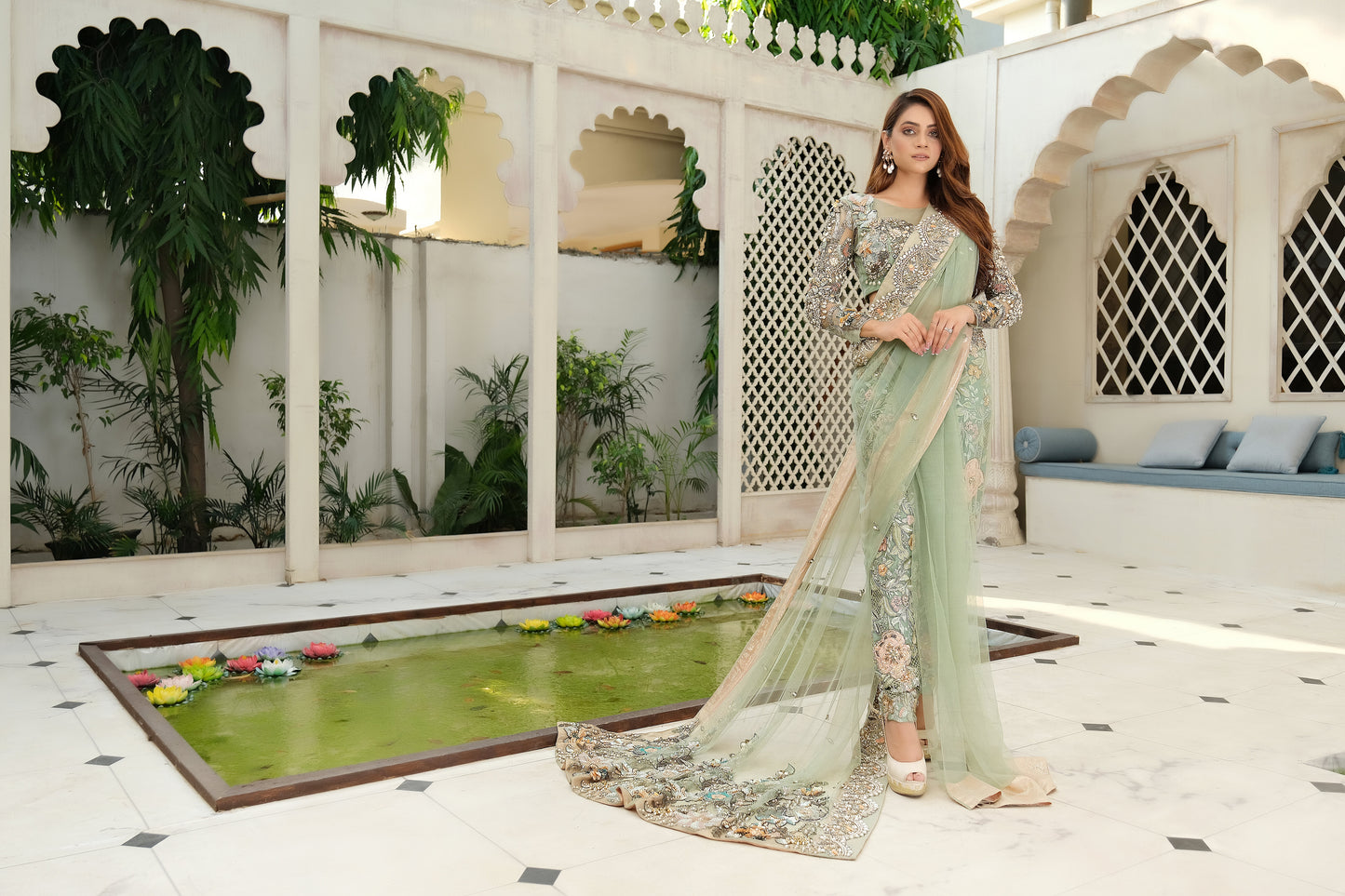 Pistachio green Pakistani formal dress with dupatta: A beautiful, embroidered dress in a light green color. The dress has an A-line silhouette and is made with high-quality, comfortable fabric. The matching dupatta is sheer and lightweight, featuring embroidery and embellishments that complement the dress. Perfect for special occasions such as weddings or formal dinners.