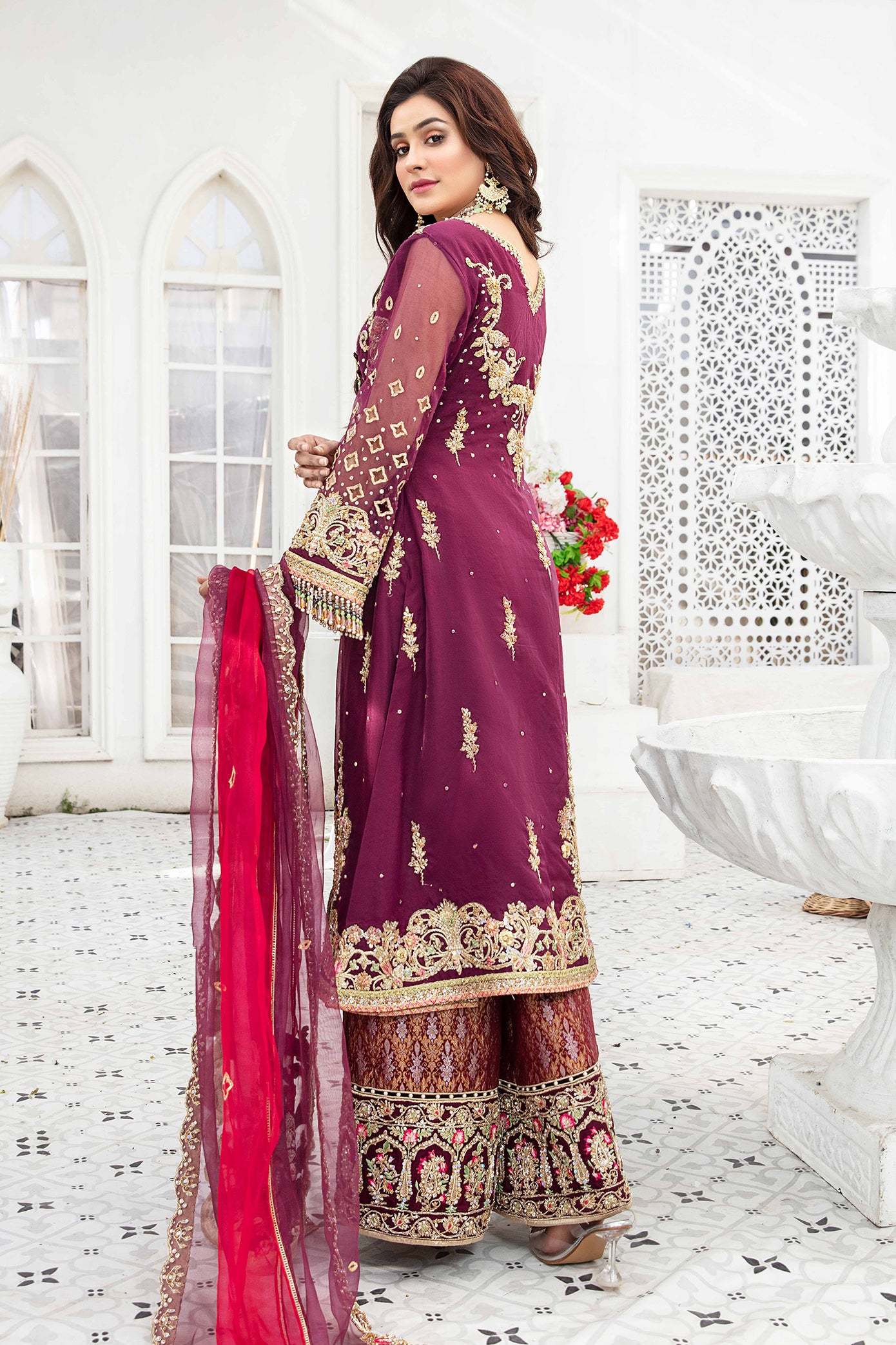 Elegant maroon and gold Pakistani formal dress - This dress features intricate gold embroidery on rich maroon fabric, with a stunning pink dupatta that complements the overall color scheme. A timeless design that is perfect for any formal occasion, this dress exudes elegance and impeccable craftsmanship