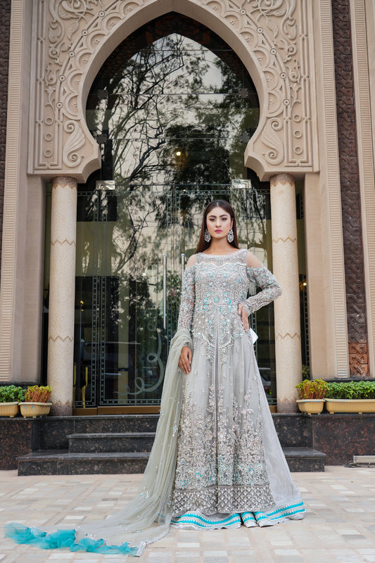 Light grey Pakistani bridal dress with intricate silver, pink, and light blue embroidery throughout bodice, sleeves, and hemline. A-line silhouette, sweetheart neckline, long slim-fitting sleeves. Comes with matching dupatta adorned with delicate embroidery. Perfect for an elegant and sophisticated bride.