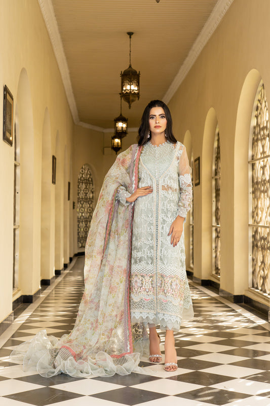 A Pakistani luxury Pret outfit consisting of a white shirt with intricate embroidery work, featuring pink fabric work at the bottom. The outfit is paired with a pink and white dupatta with flower prints.